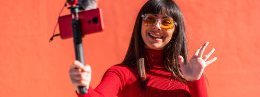 Onlyfans selfie stick model with an orange background