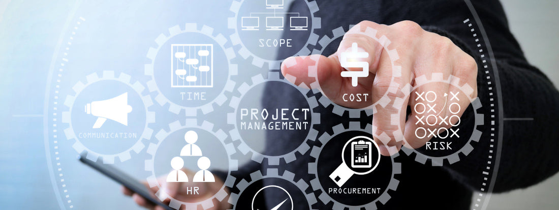 A finger points at a graphic of a handful of business tools with Project Management in the center.