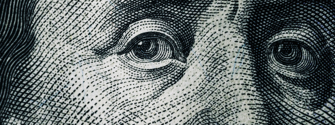 Benjamin Franklin close up of eyes on the note.