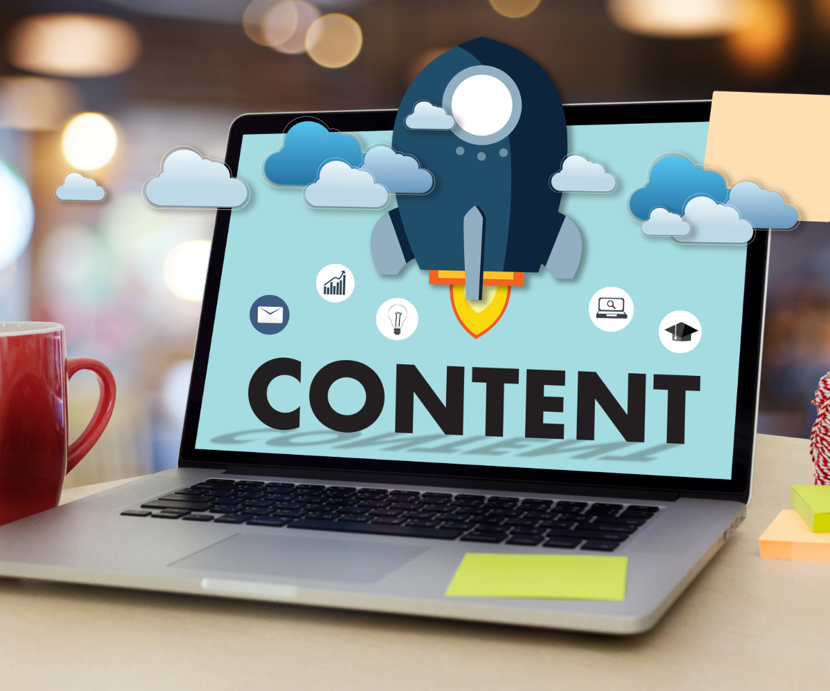 Advertising copy and creative rocket ship with content written on the bottom popping out of a laptop.