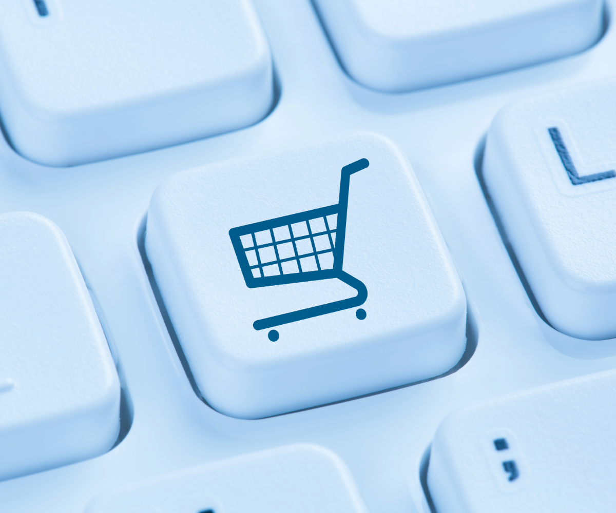 A keyboard key with a shopping cart on it in black outline showcasing ecommerce design.