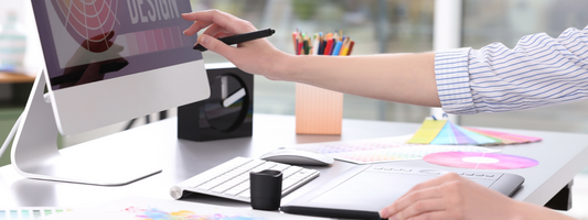 A woman's hand reaching out to a screen with a graphic design on it.