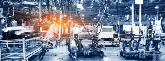 Manufacturing floor with equipment and a sun ray through a part of the window.