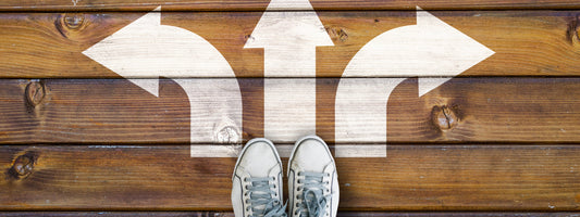 Three white arrows on the ground with feet at the bottom of them.