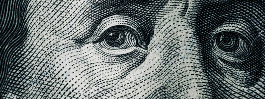 Benjamin Franklin close up of eyes on the note.