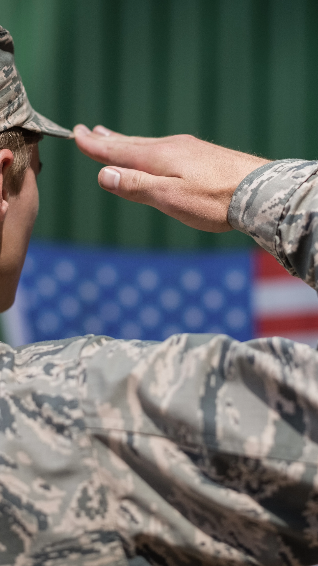 A US soldier saluting the American Flag